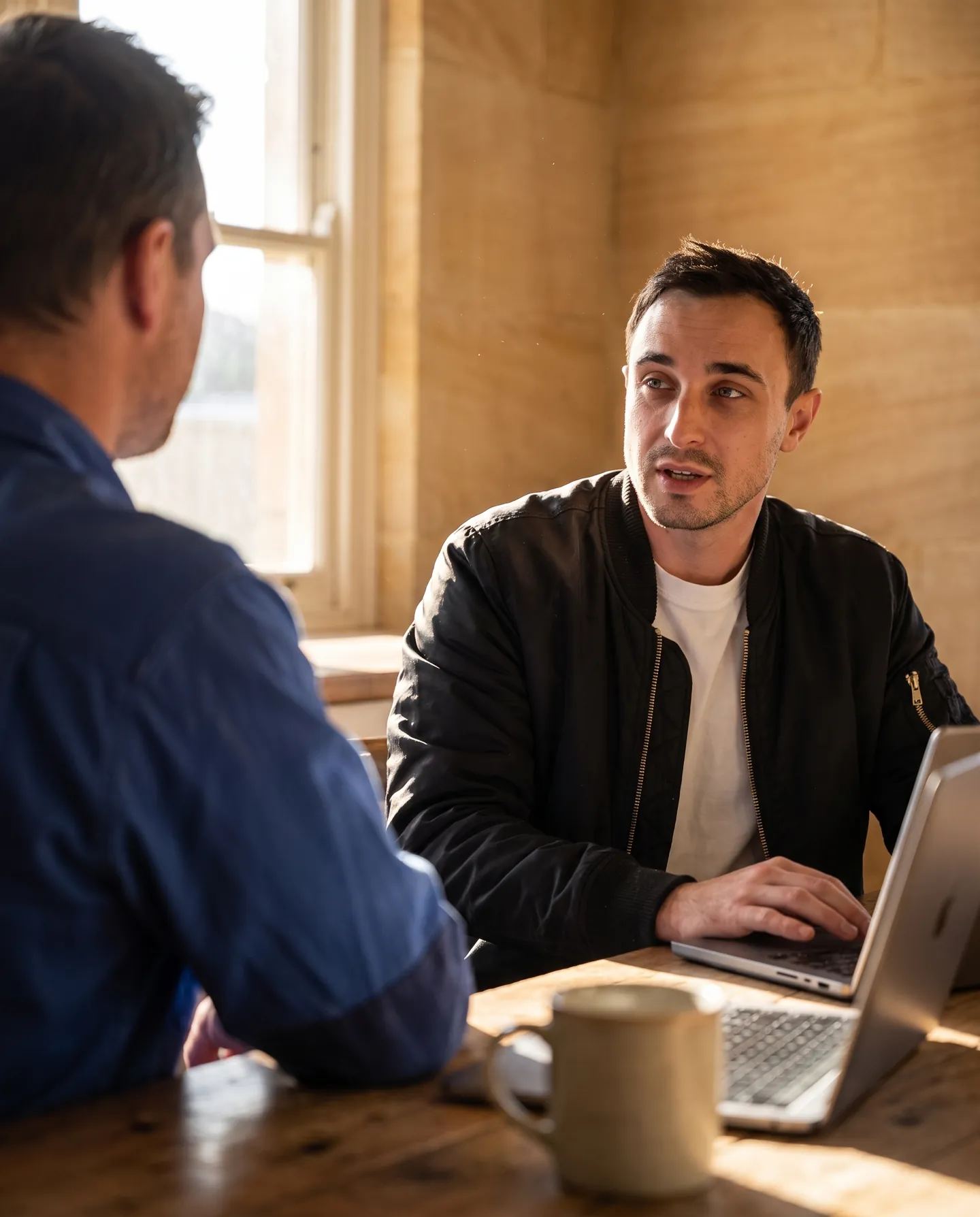 Jack Alexander talking through a job plan at a kitchen table (illustrative)